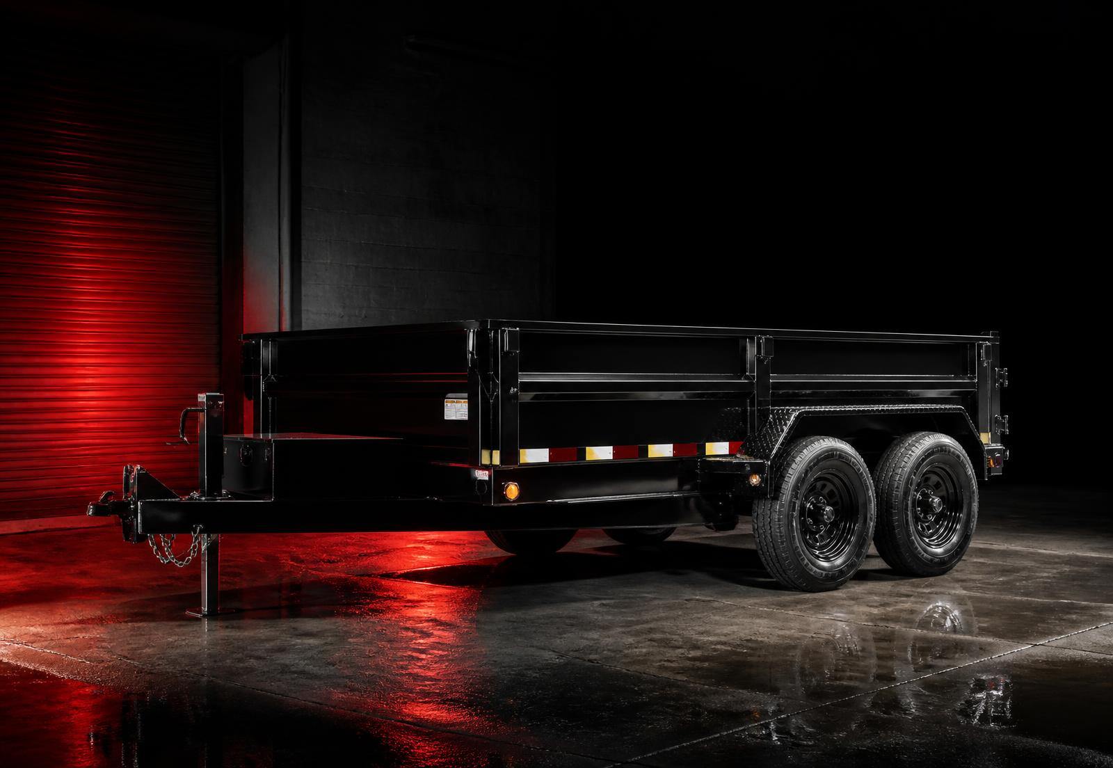 Black tandem-axle trailer in an industrial bay